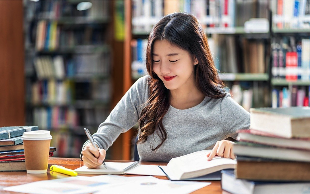 Woman Studying in Library